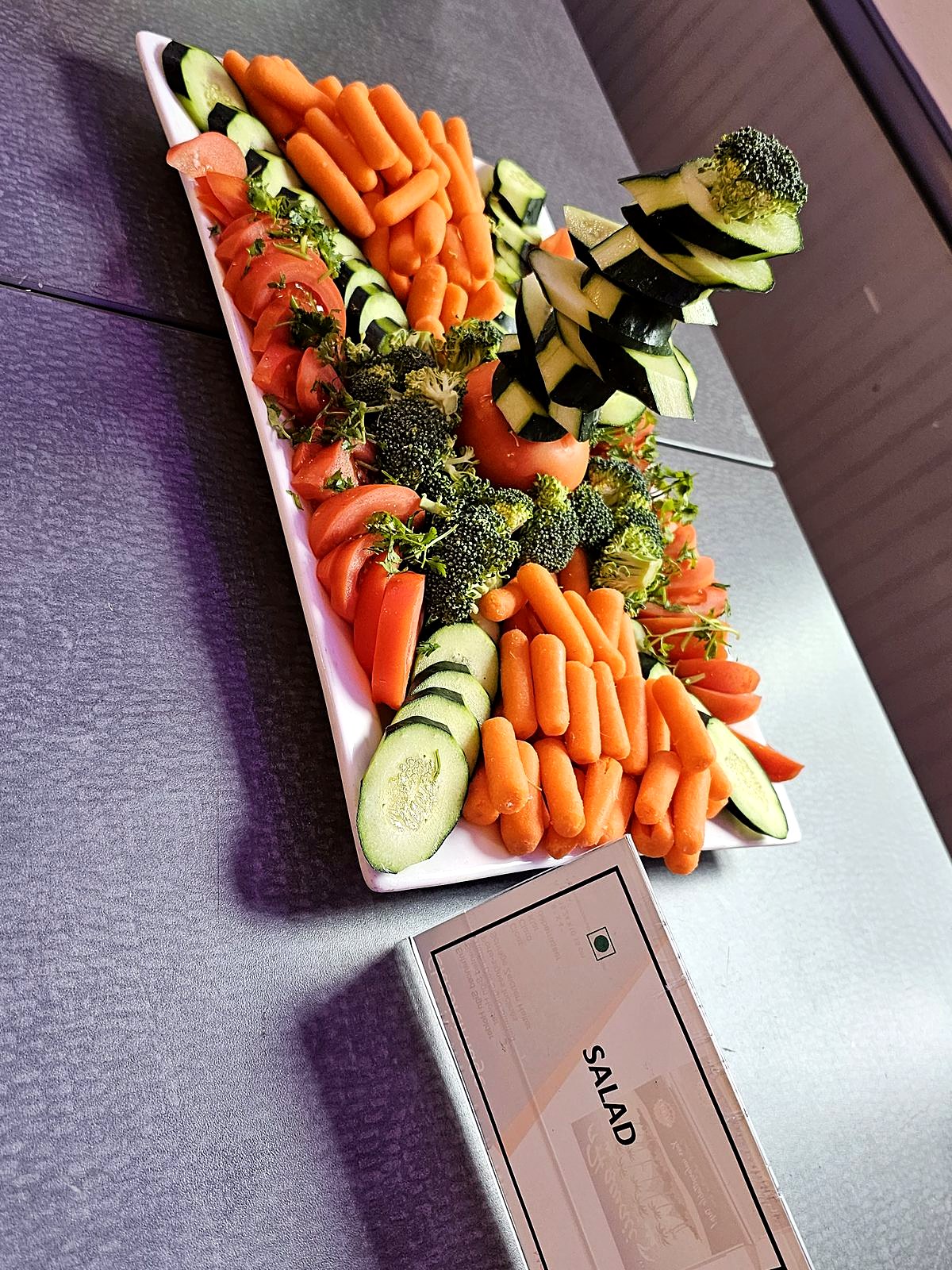 Fresh salad platter – baby carrots, cucumber, tomato and broccoli with a cucumber-tower garnish