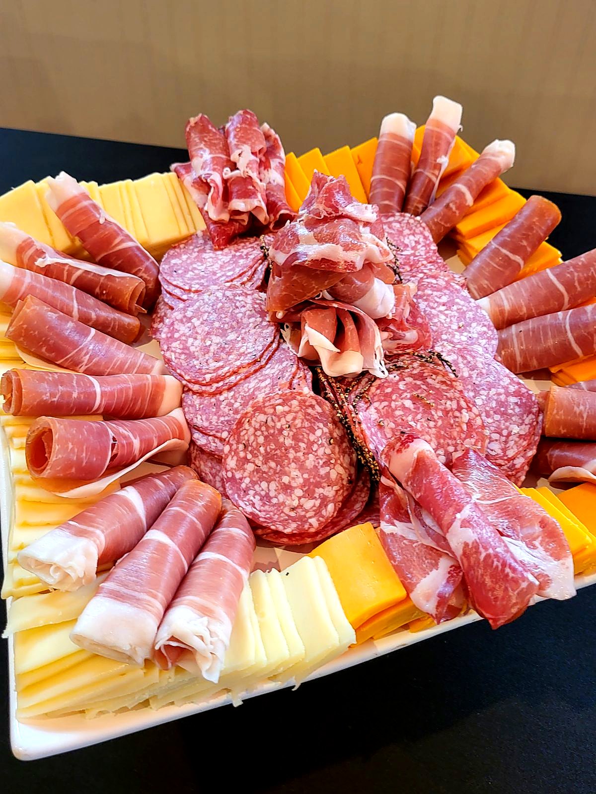 Charcuterie platter – rolled prosciutto, salami and sliced cheddar and Swiss