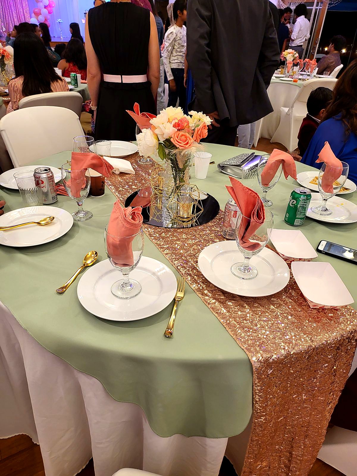 Sage and rose-gold sequin table setting with blush napkins, gold flatware and a peach rose centerpiece