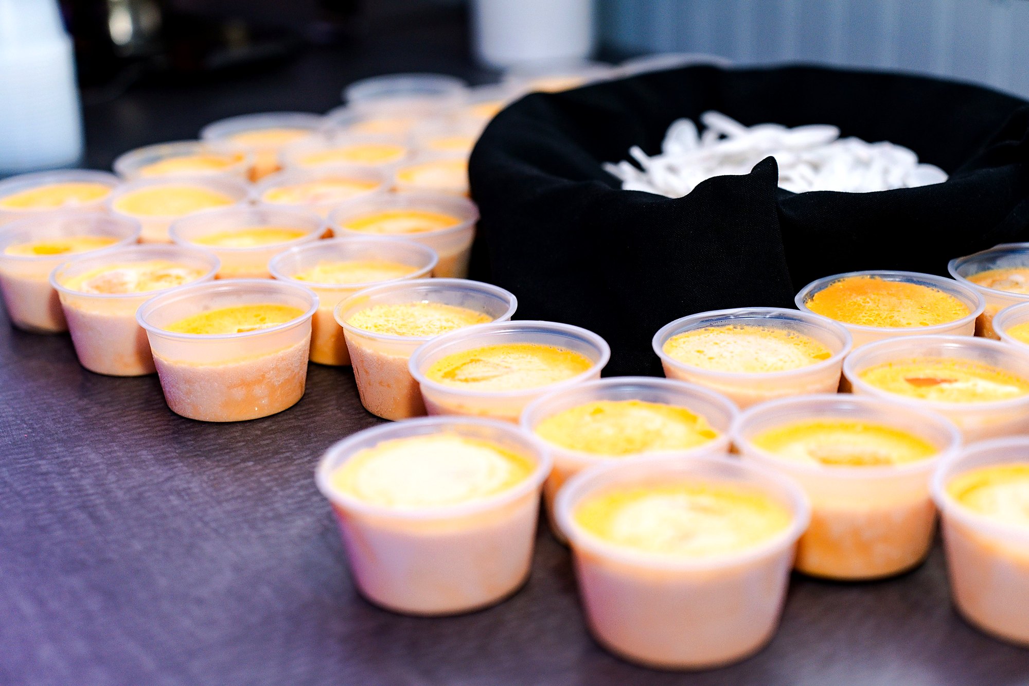 Individual kulfi cups lined up on the dessert table