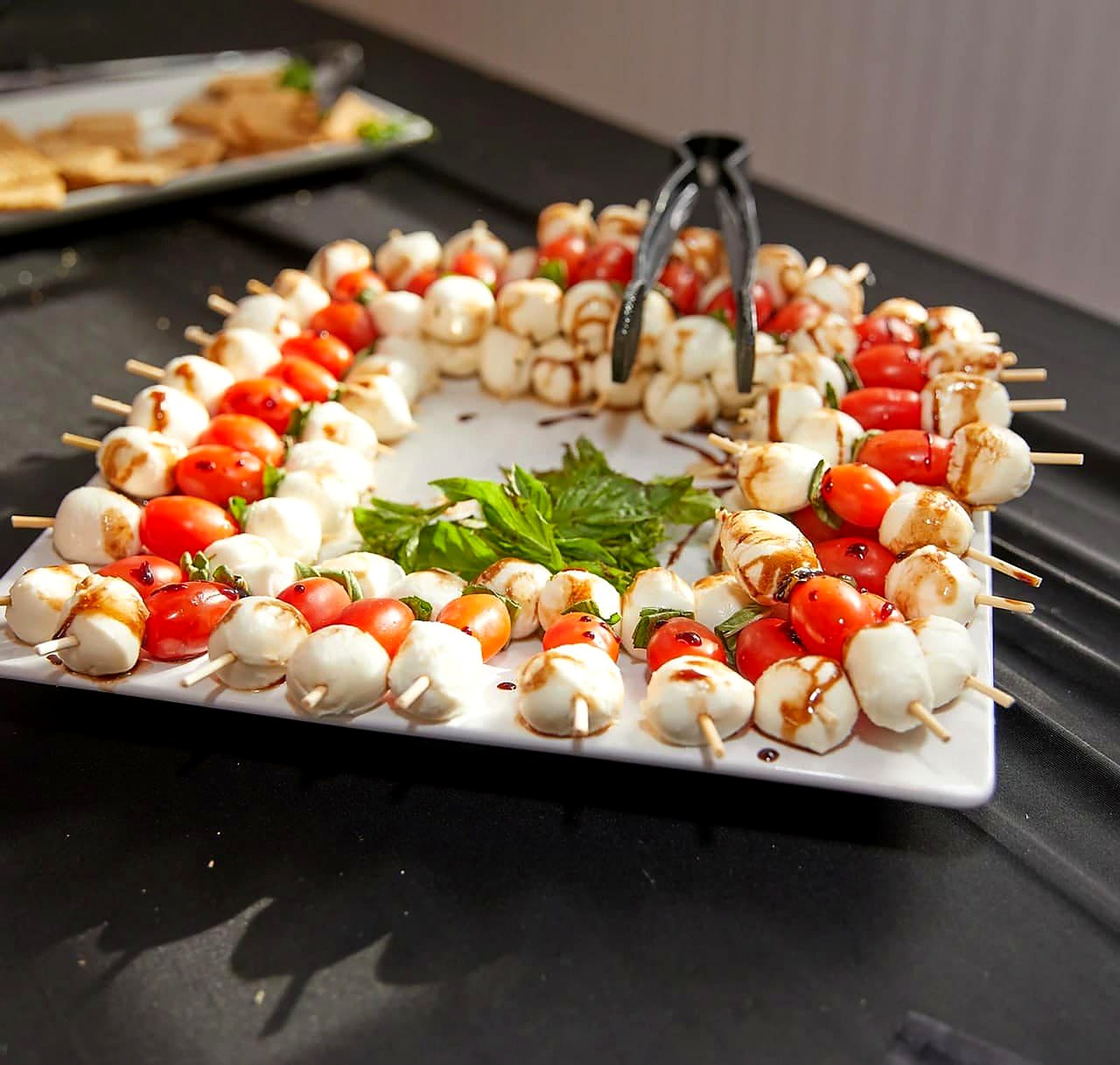 Caprese skewer wreath – mozzarella and cherry tomatoes with balsamic glaze and fresh basil