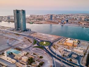 Aerial view of Ras Al Khaimah waterfront business district with modern towers, roads and commercial development