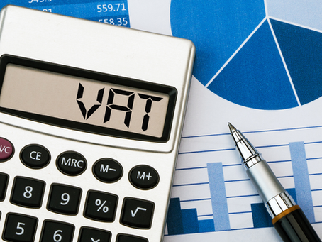VAT calculator with financial charts and pen representing VAT registration and tax compliance in the UAE