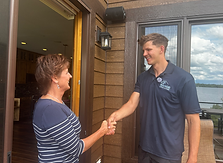 A Lake Vermillion homeowner shaking hands with a Range Window Cleaning employee