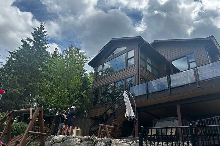 A home on Lake Vermillion that has its tall windows being cleaned