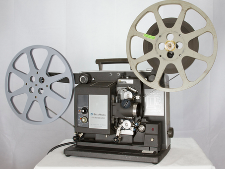 Bell and Howell 16mm projector close-up, vintage mechanical film projector, detailed shot
