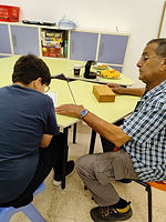 A student accompanied by an elderly mentor