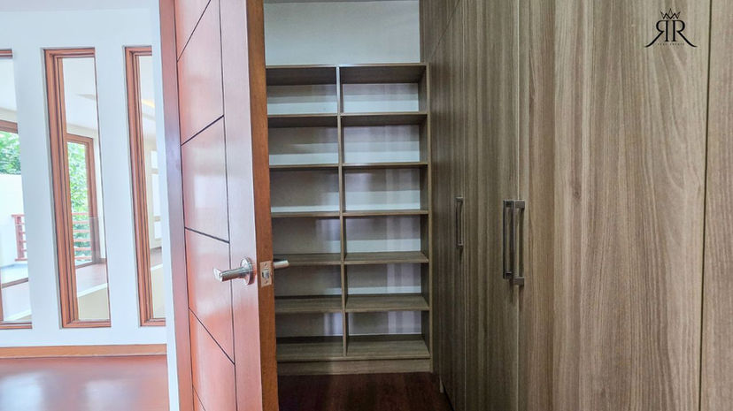 Primary bedroom with wood finished flooring in modern Paranaque City home