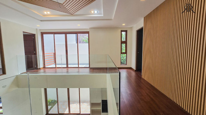 Primary bedroom with wood finished flooring in modern Paranaque City home