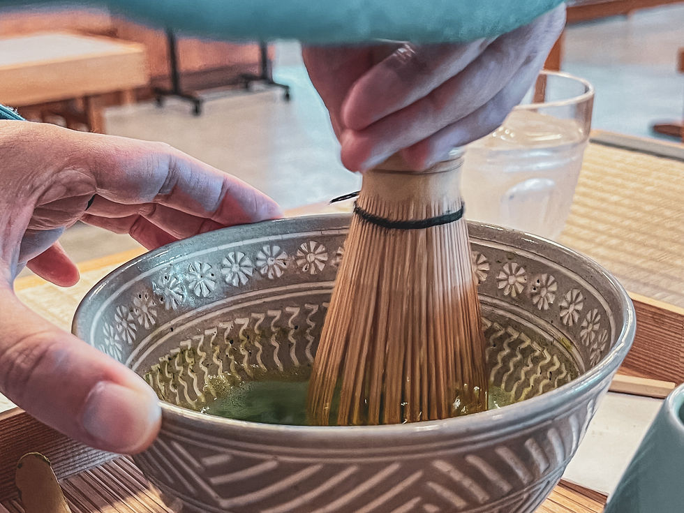 Whisking away to make a frothy matcha drink