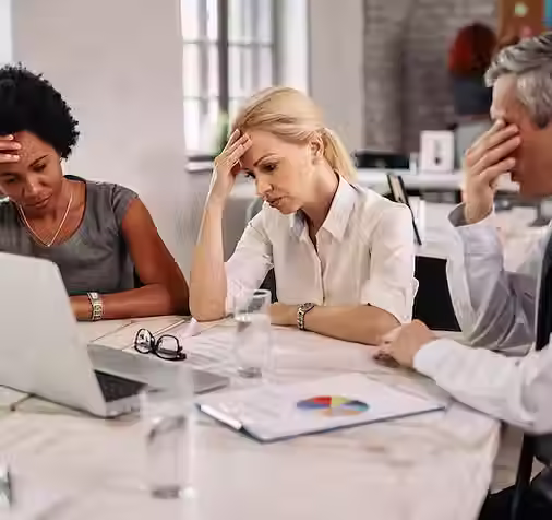 group-business-colleagues-having-headache-while-working-laptop-trying-solve-problems-meeti