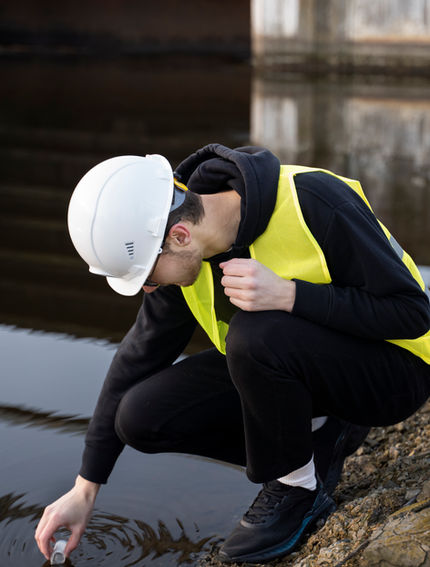 full-shot-engineer-taking-water-sample.jpg