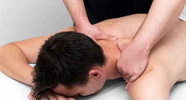 male-patient-being-given-back-massage-by-physiotherapist.jpg