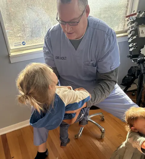 Doctor Holt working with a child during a chiropractic exam