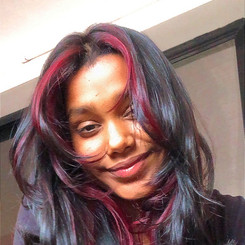 Young woman with dark hair and red streaks