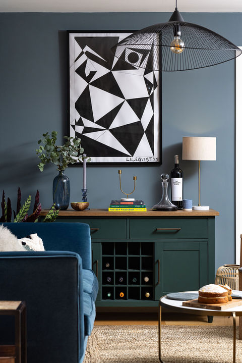 Cosy snug with blue velvet sofa, De Nimes wall panelling, personality filled space and layered textures in a Winchester home interior.