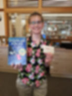 Photo of Adara holding The Ultimate Hitchhiker's Guide to the Galaxy by Douglas Adams