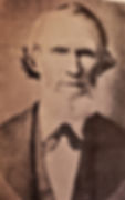 A sepia-toned portrait of Cicero Twist with a beard and formal attire, set against a plain background, exuding a serious mood. No text visible.