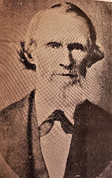 A sepia-toned portrait of Cicero Twist with a beard and formal attire, set against a plain background, exuding a serious mood. No text visible.