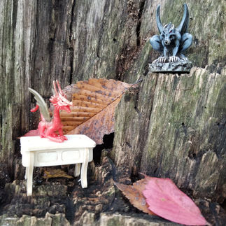Photo of the completed table with a dragon and gargoyle