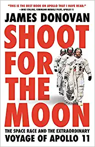 Book cover with the astronauts for the Apollo 11 suited up and walking out to the shuttle