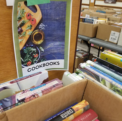 Cookbooks surrounded by books