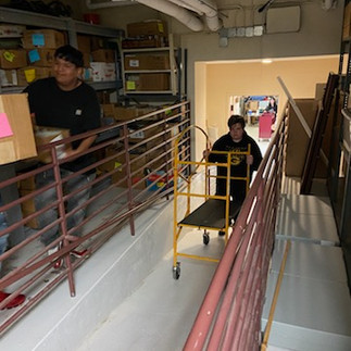 Photo of high school student pushing the cart used to transport the books