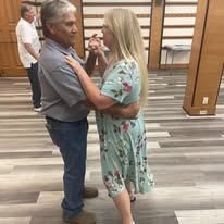 A couple learning basic dance steps in the Revere Room of the library