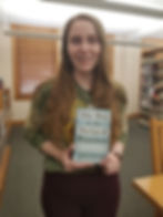 Photo of Madisyn holding the book The Boy in the Striped Pajamas by John Boyne