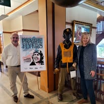A mannequin dressed as an airman with a sign reading "Prairie Flyers"