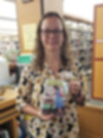 Photo of Rachel holding the book Doesn't She Look Natural by Angela Hunt