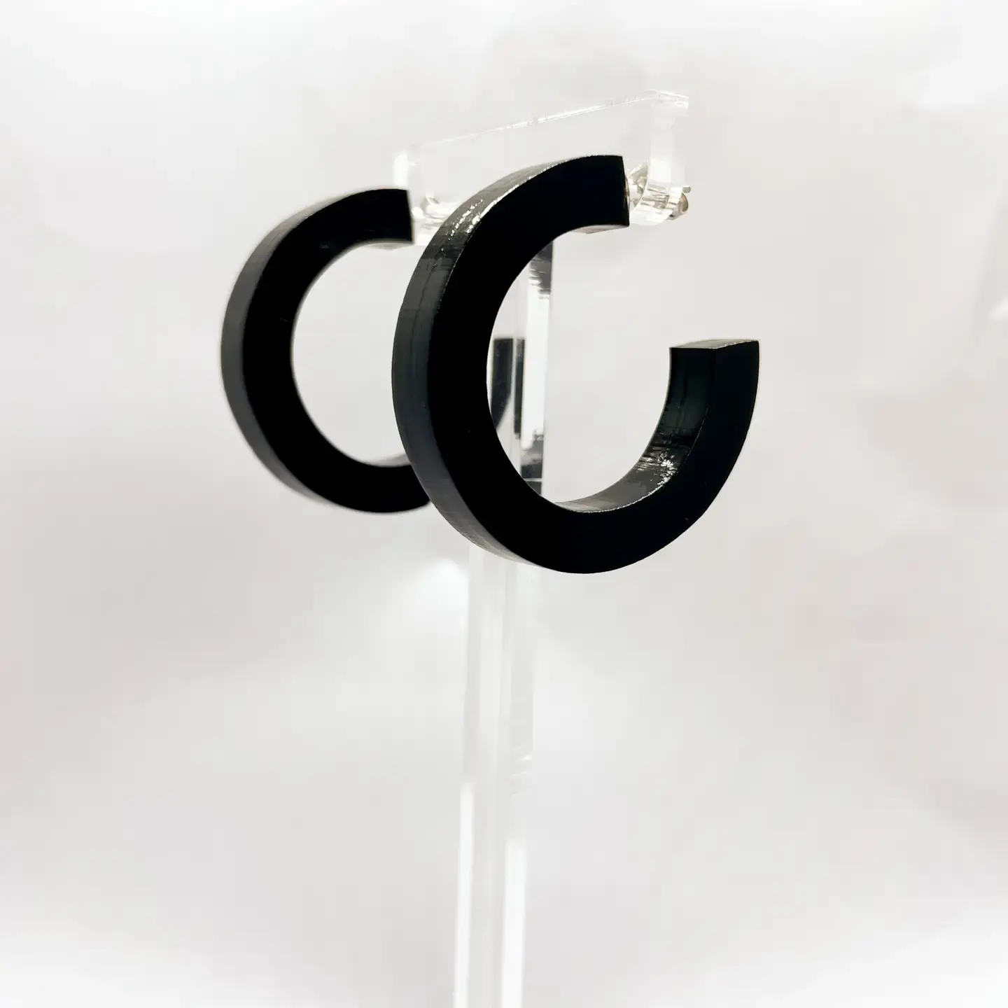 Black hoop earrings on display