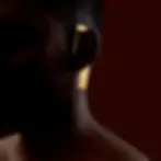 Person wearing gold rectangular earrings