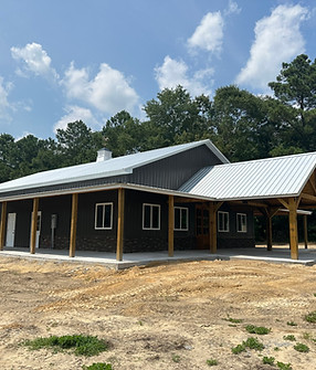 Post frame pole barn construction with metal siding and metal roofing, concrete flooring,