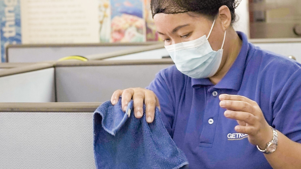 GetKlean cleaner wiping dirt off on cubicle walls