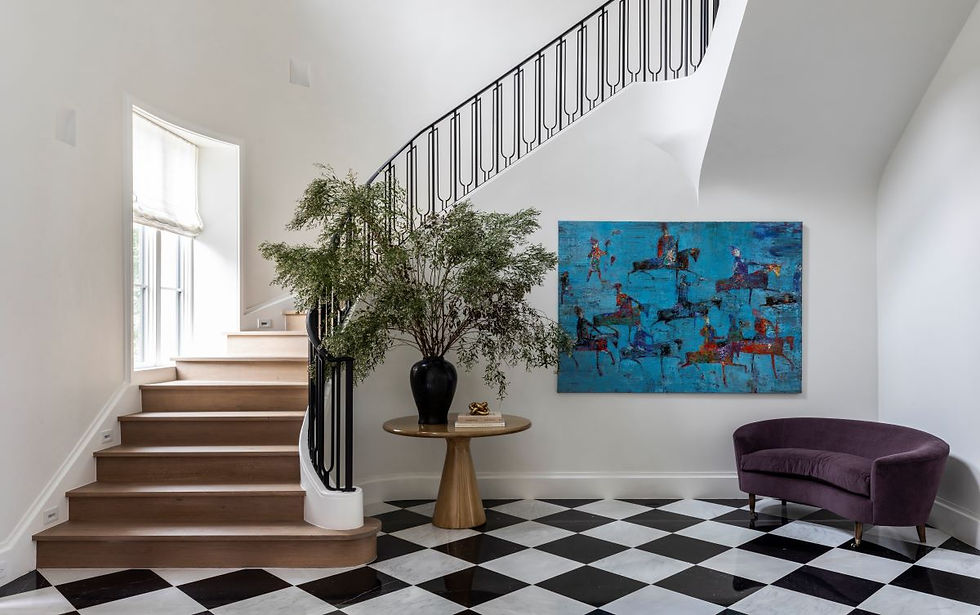 Elegant foyer with a curved staircase, art on the wall, potted plant, and a purple bench. Black and white checkered floor adds contrast.