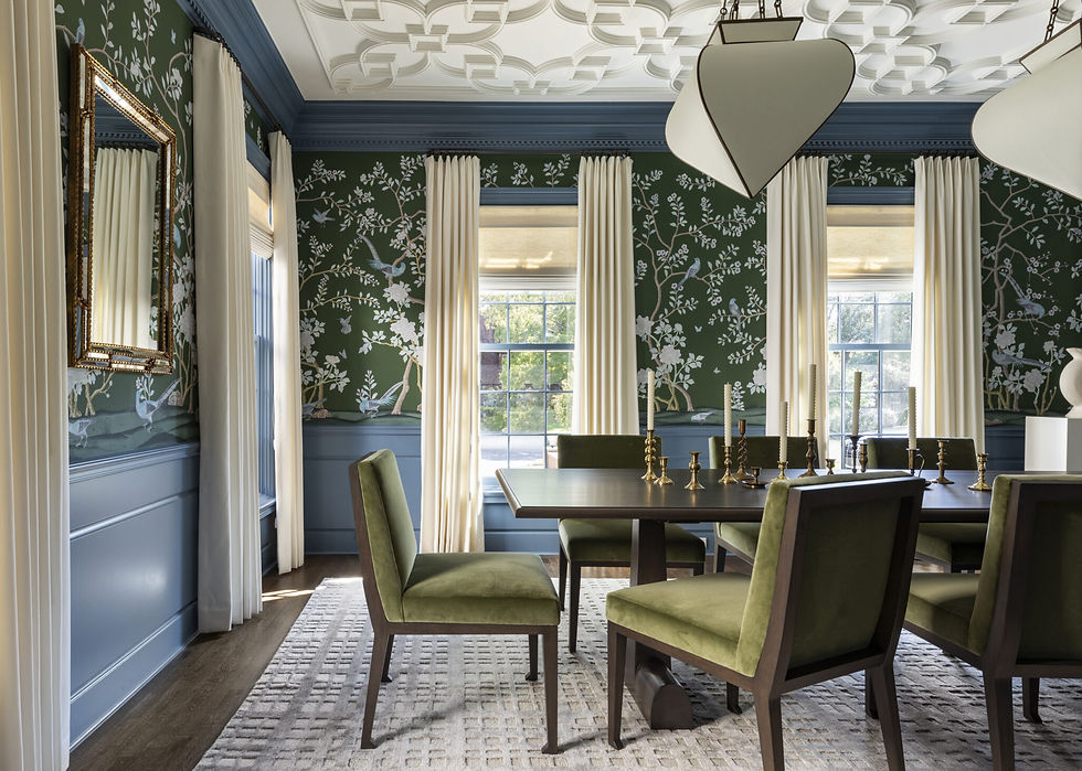 Elegant dining room with green floral wallpaper, blue trim, and cream curtains. Green chairs surround a dark table with brass candlesticks.