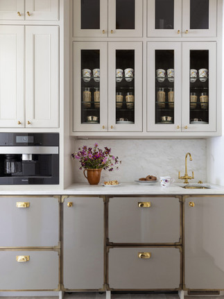 Custom kitchen cabinetry with brass hardware and thoughtfully layered styling details