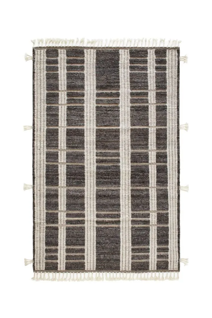 Neutral woven area rug with layered texture and timeless striped detailing