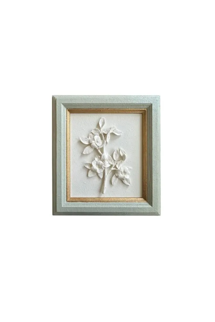 Framed plaster floral artwork with sculptural floral details and timeless styling
