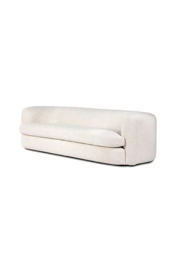 Curved ivory sofa with soft upholstery and timeless modern design