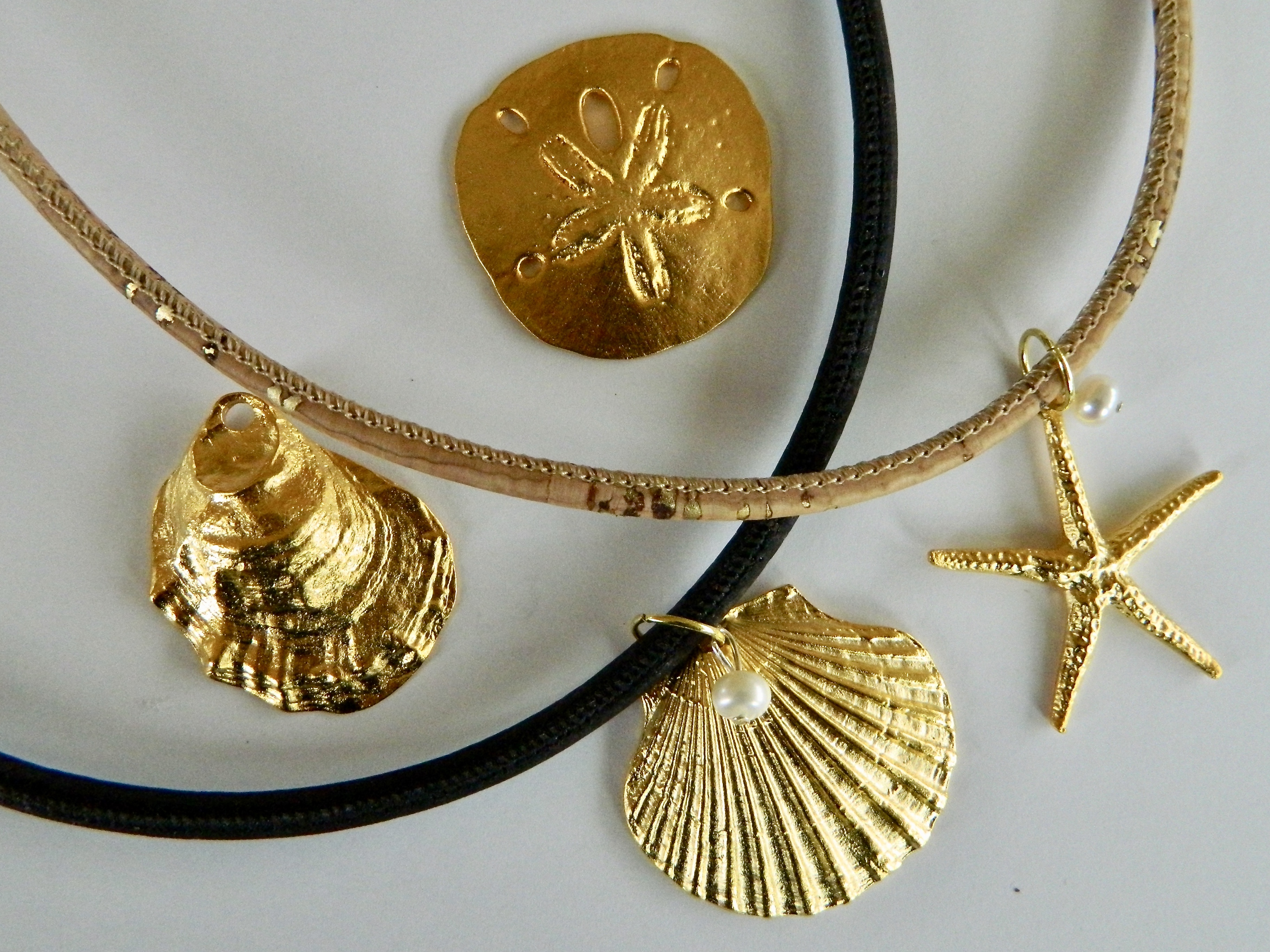 Gold Plate Pendant Necklaces on Cork