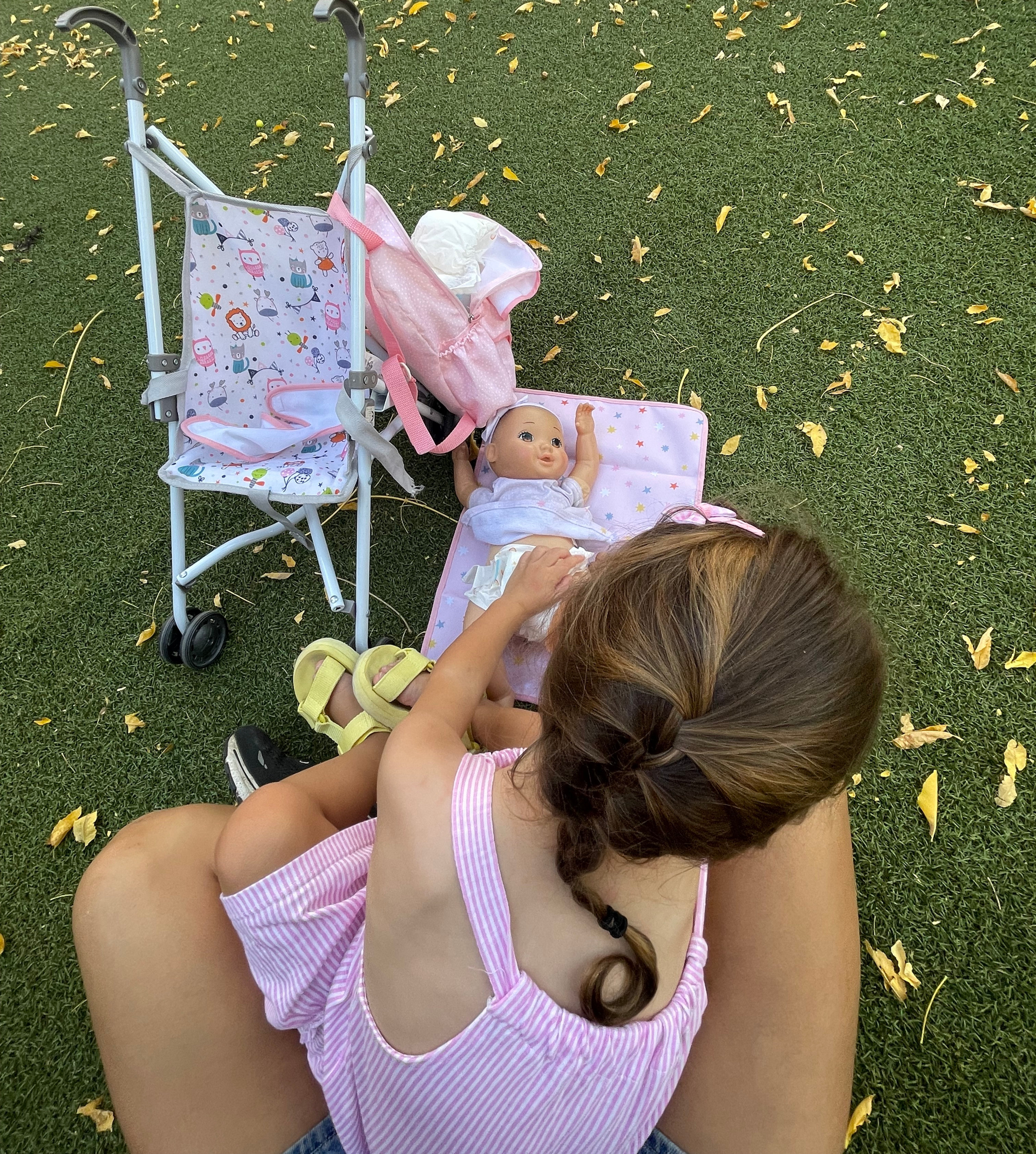 My friends' daughter changing her baby's diaper