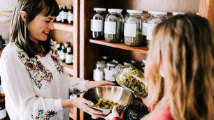 Rebecca Snow and Andie Inscoe preparing herbs in office