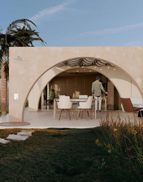 Mediterranean-style arches and rendered walls in a house renovation in Exmouth by Arcadia Studio, featuring soft cream tones 