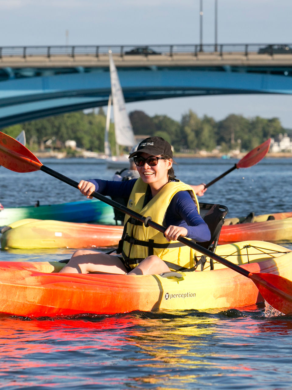 Women kayaking with her friends on Lake Quinsigamond in Worcester, MA.