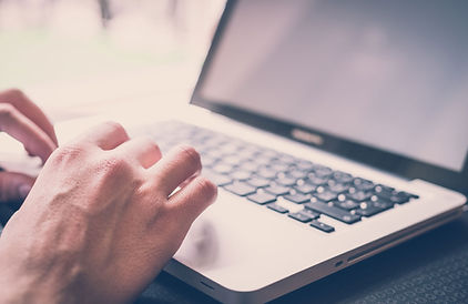 Professional using laptop to book Discovery Call with SCB Inclusion Consultancy
