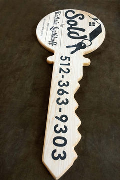 Key shaped sign for realtor used as a sales prop for business.