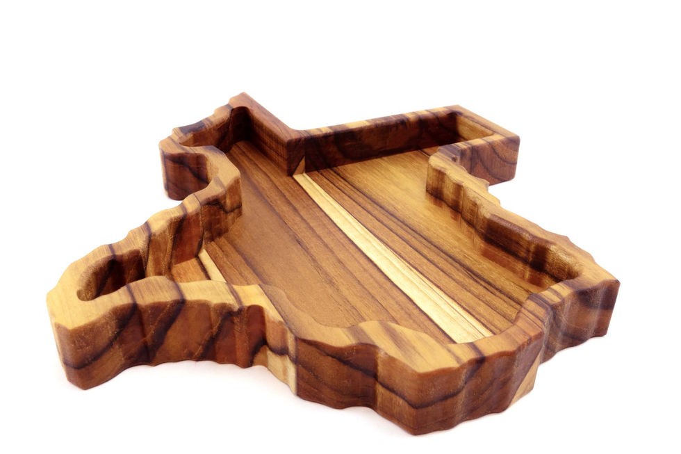 Teak wood Texas shaped catchall tray with striking variations in wood color.