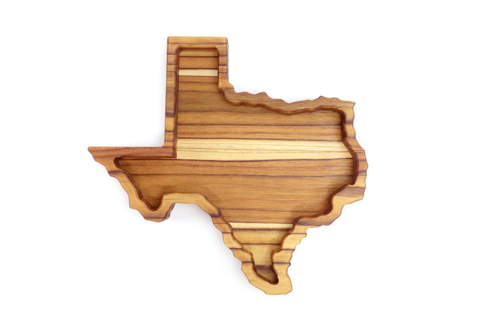 Texas shaped catchall tray made from alternating layers of teak wood.
